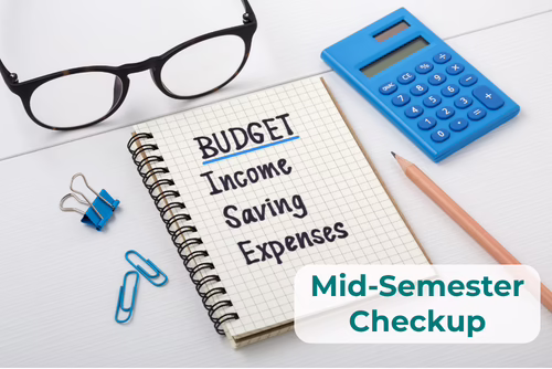 A spiral notebook displays the words Budget, Income, Savings and Expenses